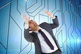Composite image of scared businessman with arms raised