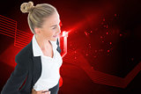 Composite image of businesswoman standing with hands on hips