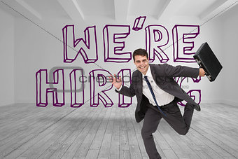 Businessman running in front of were hiring graphic