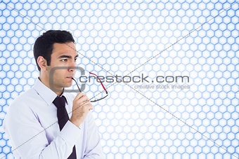 Composite image of unsmiling businessman holding glasses