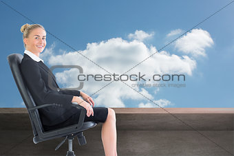 Composite image of businesswoman sitting in swivel chair