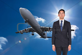 Composite image of serious businessman looking up