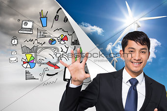 Composite image of smiling businessman holding and pointing