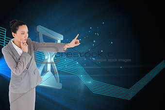Composite image of unsmiling thinking asian businesswoman pointing