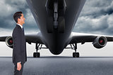 Composite image of smiling businessman looking away