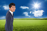 Composite image of smiling casual businessman walking