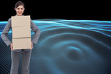 Composite image of smiling businesswoman carrying cardboard boxes