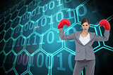 Composite image of businesswoman with boxing gloves
