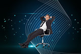 Composite image of manager relaxing in office with team in background