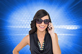 Composite image of happy brunette phoning