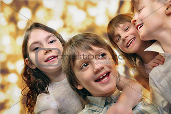 holiday portrait of happy children against bright golden backgro