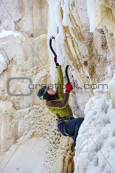 Young man climbing the ice