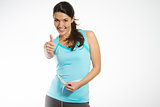 Happy fit young woman measuring her waistline