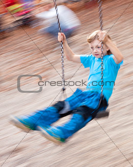 Boy on a Swing in the Playground