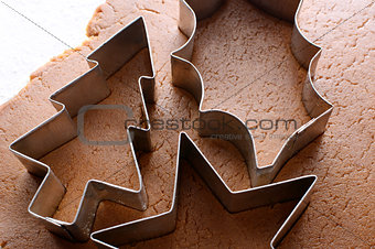 Festive cookie cutters on gingerbread dough