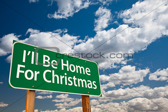 I'll Be Home For Christmas Green Road Sign Over Sky