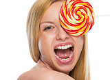 Portrait of happy teenage girl with lollypop