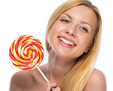 Portrait of happy teenage girl holding lollypop