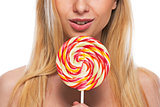 Closeup on happy teenage girl holding lollypop