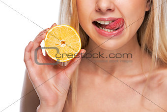 Closeup on teenage girl holding lemon