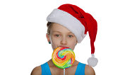 Girl with lollipop in Santa hat