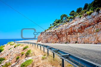 highway guardrail in the mountains and beautiful rock