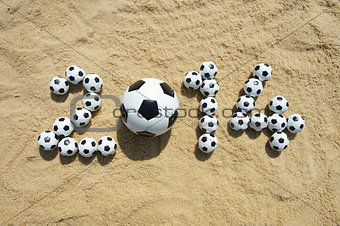 Sporty 2014 Message in Sand with Football Soccer Balls