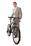 Attractive young man in a suit standing next to a bike