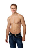 Cheerful young man in jeans with bare torso