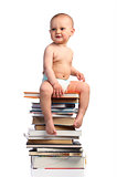 Portrait of a little boy sitting on a stack of books