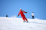 Young female skier on a mountain slope