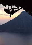 Silhouette of a rock climber at sunset. Kalymnos Island, Greece.