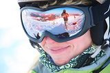 Closeup portrait of a female skier standing on a skiing slope