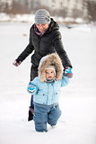 Little boy and his mom having fun on a winter day