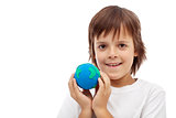 Happy kid holding earth globe made of clay