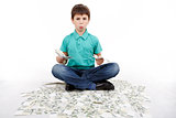 boy sitting on money, money concept