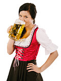 Woman wearing dirndl and drinking Oktoberfest  beer