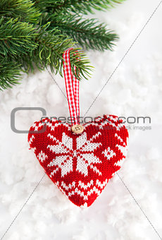 Knitted heart on the snow