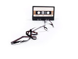 retro cassette with loose tape over a white background