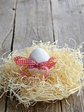 Easter eggs in nest on a wooden background