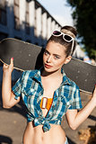 beautiful lady with skateboard in the city