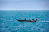 Old fishing boat goes by sea - fishermen working