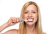 Portrait of teenage girl brushing teeth