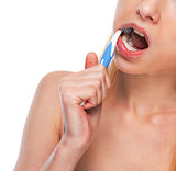 Closeup on teenage girl brushing teeth