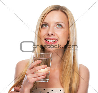 Portrait of happy teenage girl with cup of water looking on copy