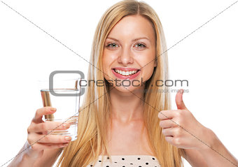 Portrait of smiling teenage girl showing and thumbs up