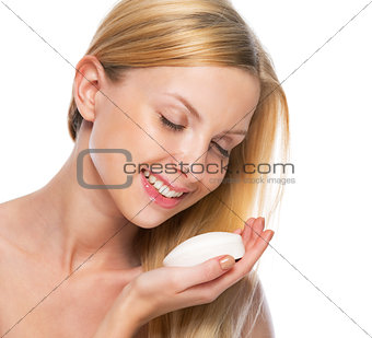 Portrait of teenage girl holding soap bar