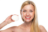 Portrait of smiling teenage girl showing soap bar
