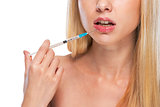 Closeup on teenage girl making lips injection