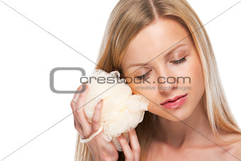 Portrait of relaxed teenage girl holding wisp of bast